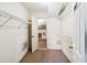 A walk-in closet features wire shelving and an open doorway to another closet at 1085 Island Way, Leesburg, FL 34748