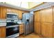 Kitchen featuring stainless steel appliances, wooden cabinets, and hardwood floors at 1085 Island Way, Leesburg, FL 34748