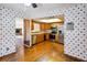 Bright kitchen with stainless steel appliances, wood cabinetry, and a pass-through window at 1085 Island Way, Leesburg, FL 34748