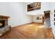 Open-concept living space with hardwood floors, fireplace, and staircase to the second floor at 1085 Island Way, Leesburg, FL 34748