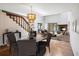 Bright, staged living room featuring a fireplace, chandelier, and staircase at 1085 Island Way, Leesburg, FL 34748