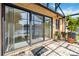 Outdoor patio area with plants, decorative pots and glass sliding doors with lake views at 1085 Island Way, Leesburg, FL 34748