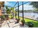 Enjoy the outdoors in this screened patio with views of the lake and dock at 1085 Island Way, Leesburg, FL 34748