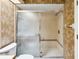 Bathroom with a shower behind sliding glass doors at 1085 Island Way, Leesburg, FL 34748