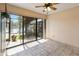 Cozy sunroom with tile floors and sliding glass doors overlooking the lake at 1085 Island Way, Leesburg, FL 34748
