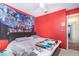 Red bedroom features a closet, fan, and a comfortable looking bed at 109 Lakepointe Cir, Kissimmee, FL 34743