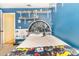 Fun bedroom with bright blue walls, Star Wars theme, and display shelves at 109 Lakepointe Cir, Kissimmee, FL 34743