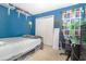 Blue bedroom with a white closet, desk, and Star Wars themed décor at 109 Lakepointe Cir, Kissimmee, FL 34743