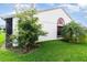 Exterior side view of house with green lawn and lush landscaping at 109 Lakepointe Cir, Kissimmee, FL 34743