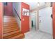 Bright foyer features a staircase, tile flooring, and decorative art, creating an inviting entrance at 109 Lakepointe Cir, Kissimmee, FL 34743