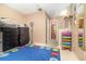 Neutral bedroom hallway with colorful storage and access to the bathroom at 109 Lakepointe Cir, Kissimmee, FL 34743