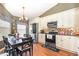 Modern kitchen featuring stainless steel appliances, ample cabinet space, and a cozy dining area at 109 Lakepointe Cir, Kissimmee, FL 34743