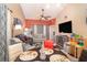 Bright and airy living space with contemporary furnishings, a dining area, and entertainment center at 109 Lakepointe Cir, Kissimmee, FL 34743