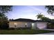Charming single-story home featuring a well-maintained lawn, complemented by lush landscaping and a two car garage at 1114 Camden W Way, Poinciana, FL 34758