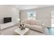 Inviting living room with comfortable seating, complemented by stylish decor and an abundance of natural light at 1114 Camden W Way, Poinciana, FL 34758