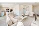 Bright, open-concept living room with stylish furniture, adjacent to a modern kitchen and dining area at 1114 Camden W Way, Poinciana, FL 34758
