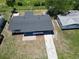 Aerial view of home with a gray roof, detached garage, and large front yard at 1118 Roberta Ave, Orlando, FL 32825