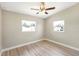 Bedroom featuring wood-look floors, a ceiling fan, and two windows at 1118 Roberta Ave, Orlando, FL 32825