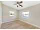 Light-filled bedroom featuring wood-look floors and two windows at 1118 Roberta Ave, Orlando, FL 32825