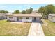 This home has a modern exterior, driveway, lawn, and is in a residential area at 1118 Roberta Ave, Orlando, FL 32825