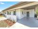 Covered front porch with brick accents, painted concrete floor, and landscaping at 1118 Roberta Ave, Orlando, FL 32825