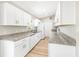 Bright kitchen featuring all-white cabinets, granite countertops, and modern appliances at 1118 Roberta Ave, Orlando, FL 32825