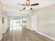 Bright living room featuring laminate floors and sliding glass doors to backyard at 1118 Roberta Ave, Orlando, FL 32825