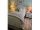 Serene bedroom with a white bed, matching nightstands, and soft lighting at 1121 Alcove Loop, The Villages, FL 32162