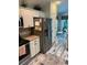 Well-lit kitchen with white cabinets, granite countertops, and stainless steel appliances at 1121 Alcove Loop, The Villages, FL 32162