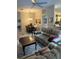 Open-concept living room featuring a dining area and a comfortable sofa with tile flooring at 1121 Alcove Loop, The Villages, FL 32162