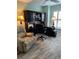 Spacious home office with a dark wood desk, comfortable chair, and built-in shelving at 1121 Alcove Loop, The Villages, FL 32162
