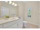 Traditional bathroom with a white vanity, granite counters, and stylish lighting at 1158 Sweet Heather Ln, Apopka, FL 32712