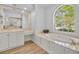Bathroom featuring a soaking tub, an arched window, and vanity space at 1158 Sweet Heather Ln, Apopka, FL 32712