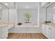 Bathroom with a large soaking tub, an arched window, and dual vanities at 1158 Sweet Heather Ln, Apopka, FL 32712