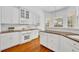 Bright kitchen with white cabinets, granite countertops, stainless steel appliances, and natural light at 1158 Sweet Heather Ln, Apopka, FL 32712