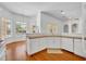 Open kitchen with white cabinetry, granite countertops, and hardwood floors overlooking backyard at 1158 Sweet Heather Ln, Apopka, FL 32712