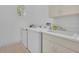 Bright laundry room with a washer, dryer, sink, storage cabinets, and natural light at 1158 Sweet Heather Ln, Apopka, FL 32712