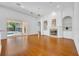 Open living room with fireplace, built-in shelving, and sliding glass doors to pool area at 1158 Sweet Heather Ln, Apopka, FL 32712