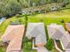 Aerial view of home with manicured lawn and surrounding trees at 118 Ventana Dr, Poinciana, FL 34759
