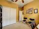 Cozy bedroom with neutral walls, a ceiling fan, and double closets for ample storage space at 118 Ventana Dr, Poinciana, FL 34759