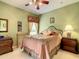 Cozy bedroom featuring neutral carpet, ample natural light, and stylish traditional decor at 118 Ventana Dr, Poinciana, FL 34759