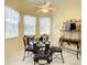 Cozy breakfast nook with a glass table, ornate chairs, and bright natural light from surrounding windows at 118 Ventana Dr, Poinciana, FL 34759