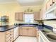 Bright kitchen features updated appliances, ample counter space, and classic cabinetry for a functional design at 118 Ventana Dr, Poinciana, FL 34759