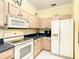 Well-lit kitchen featuring light wood cabinets, modern appliances, and functional countertop space at 118 Ventana Dr, Poinciana, FL 34759
