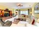 Spacious living room with a plush sectional sofa, neutral color palette, and a large entertainment center at 118 Ventana Dr, Poinciana, FL 34759