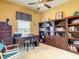 Inviting office with custom built-in bookshelves, neutral carpet, and stylish traditional decor at 118 Ventana Dr, Poinciana, FL 34759