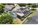An aerial view displays a pool, screened-in enclosure, solar panels, lush landscaping, and well-maintained surroundings at 1201 Shelter Rock Rd, Orlando, FL 32835