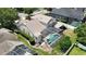Aerial view of the home showcasing pool, screened-in enclosure, landscaping, and proximity to neighboring properties at 1201 Shelter Rock Rd, Orlando, FL 32835