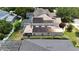 A high angle aerial view highlights solar panels, screened pool, landscaping and neighbor's roofs at 1201 Shelter Rock Rd, Orlando, FL 32835