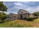 An appealing backyard featuring an outdoor living space with screened enclosure and manicured landscaping at 1201 Shelter Rock Rd, Orlando, FL 32835